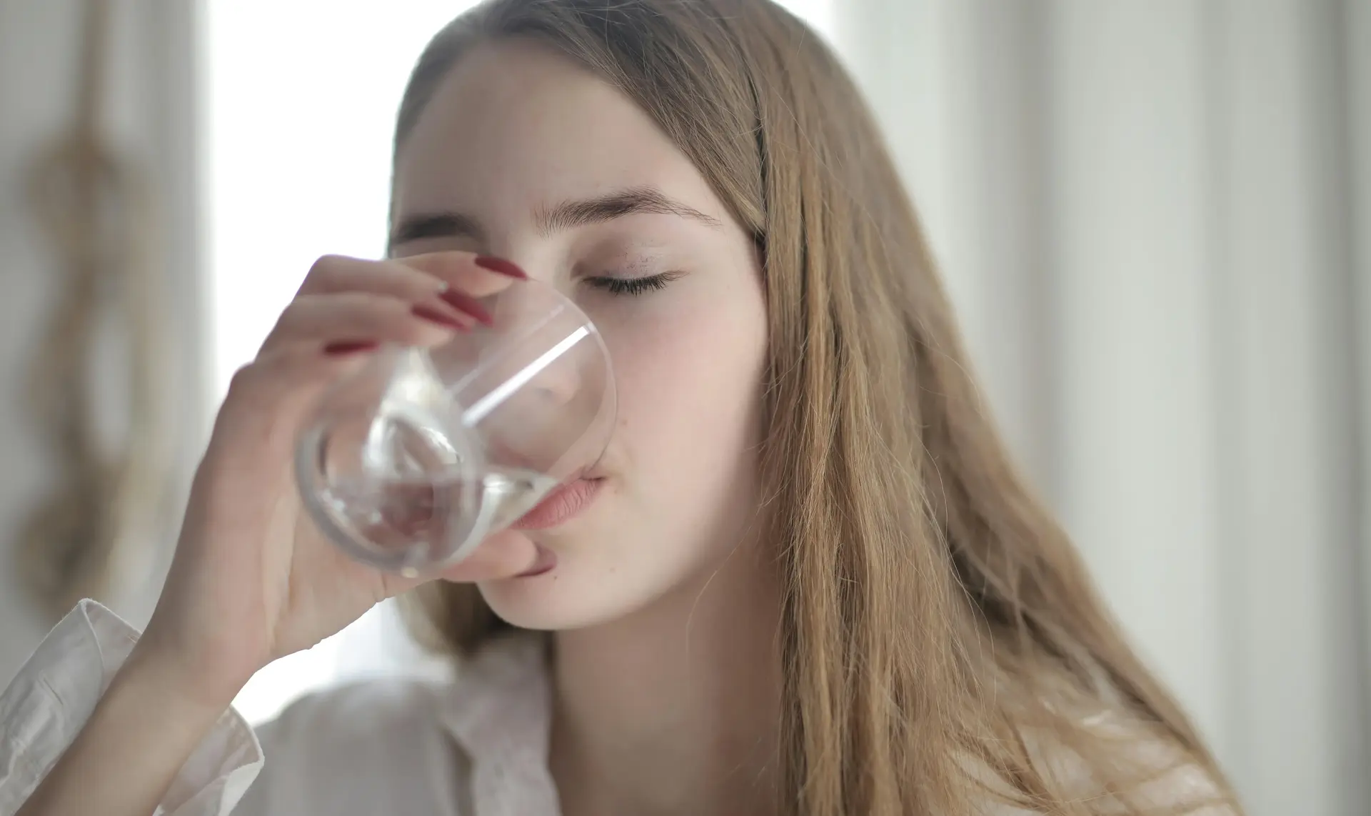 Someone Drinking Water in Their Alcohol Detox